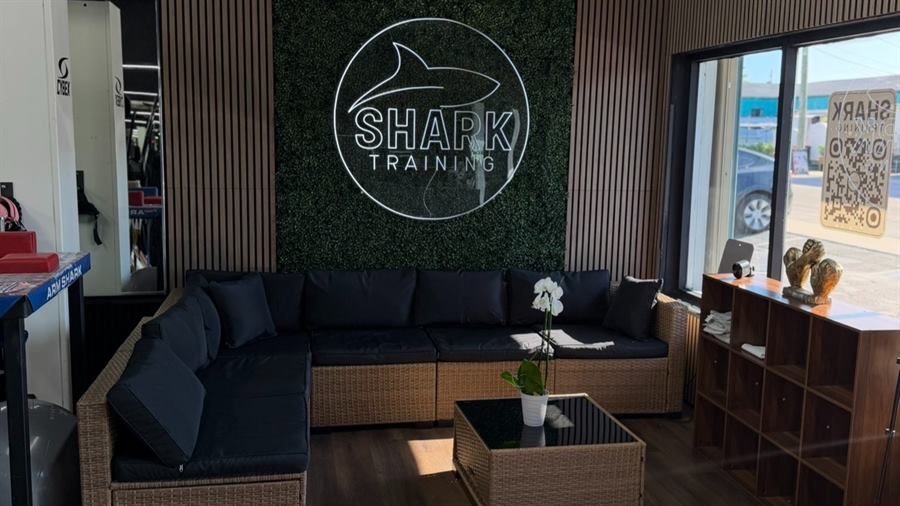 Front lounge with the Shark Training logo wall